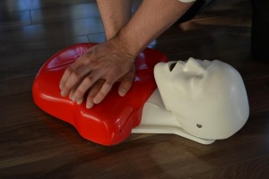 Chest compressions on a  CPR training mannequin.