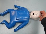 CPR Instructor at work demonstrating how child CPR is Done